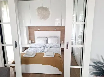 a small bedroom with a bed in a cabinet at Classy 2-room Apartment with Private Garden and Air Conditioning- Old Town in Kraków