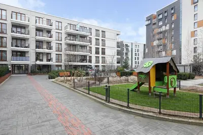 a smallshed in a park in front of a building at Classy 2-room Apartment with Private Garden and Air Conditioning- Old Town in Kraków