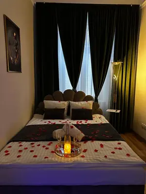 a bedroom with a bed with a candle on it at Jacuzzi Berka Apartamenty in Kraków