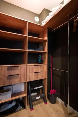 a room with a closet with wooden shelves at Modern apt next to train station in Kraków