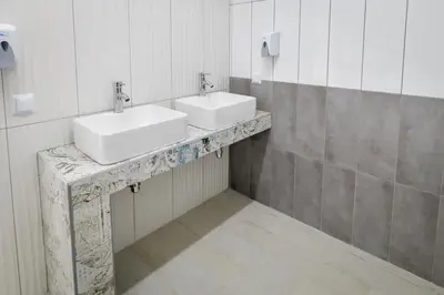 a bathroom with two sinks on a marble counter at KempingZator Glamping in Zator