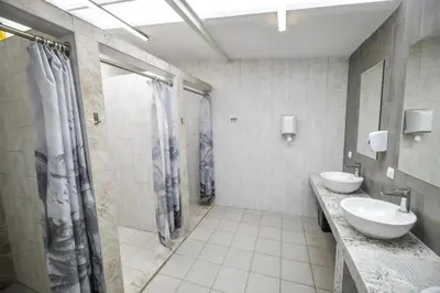 a bathroom with two sinks and a shower at KempingZator Glamping in Zator