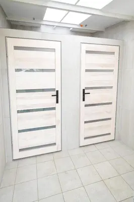 two doors in a room with white walls at KempingZator Glamping in Zator