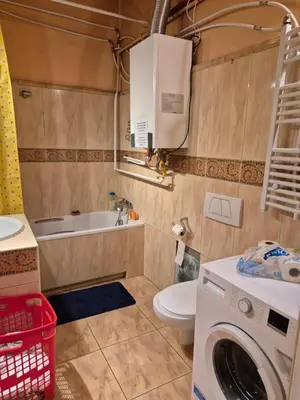 a bathroom with a toilet and a washing machine at Agnieszki Pokoj nr 2 in Kraków