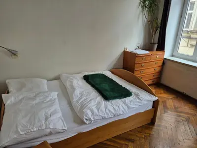 a bedroom with a bed with a green pillow on it at Agnieszki Pokoj nr 2 in Kraków