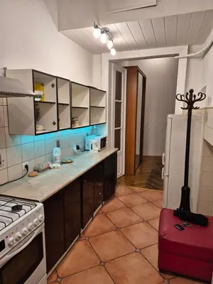 a kitchen with a white refrigerator and a red suitcase at Agnieszki Pokoj nr 3 in Kraków