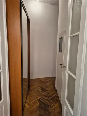 a hallway with a door and a wooden floor at Agnieszki Pokoj nr 3 in Kraków