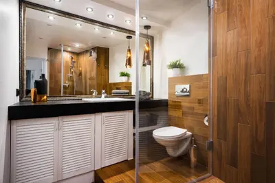 a bathroom with a toilet and a sink and a shower at Apartament Felicjanek in Kraków
