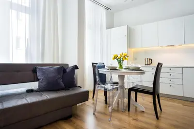a living room with a couch and a table with chairs at Apartament Felicjanek in Kraków