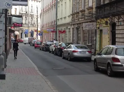 a street with cars parked on the side of the road at Apartament Felicjanek in Kraków