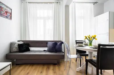 a living room with a couch and a table at Apartament Felicjanek in Kraków