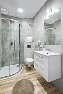 a bathroom with a shower and a toilet and a sink at Old Town Apartmens - B33 in Kraków