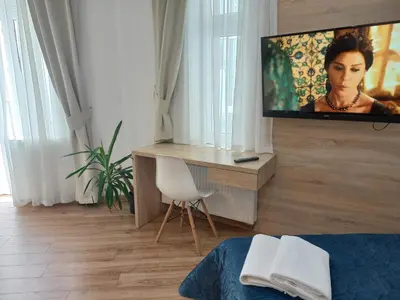 a living room with a tv on a wall at Old Town Apartmens - B33 in Kraków
