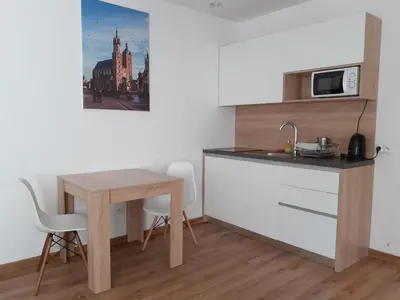 a small kitchen with a table and a microwave at Old Town Apartmens - B33 in Kraków