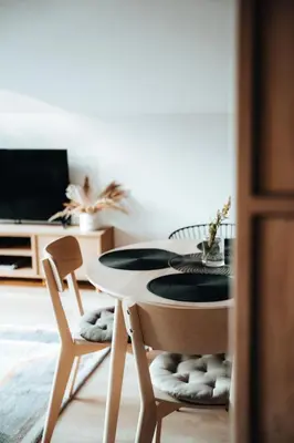 a living room with a couch and a table at Budzi nas las Marcyporęba - Duży domek in Marcyporęba