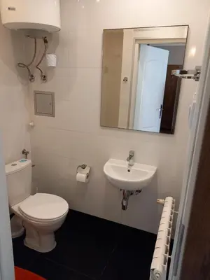 a bathroom with a toilet and a sink at Mini Apartamenty Centrum in Kraków