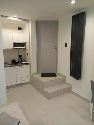 a small kitchen with stairs in a room at Mini Apartamenty Kraków in Kraków