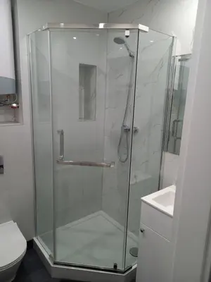 a shower with a glass door in a bathroom at Mini Apartamenty Kraków in Kraków