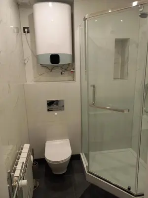 a bathroom with a toilet and a glass shower at Mini Apartamenty Kraków in Kraków