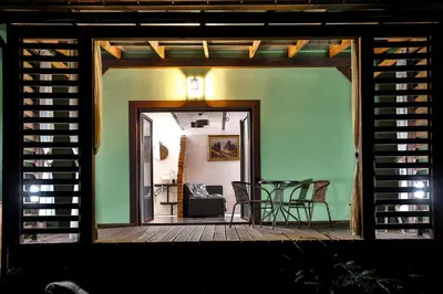 a screened in porch with a table and chairs at Apartament Zielona Willa in Skomielna Biała