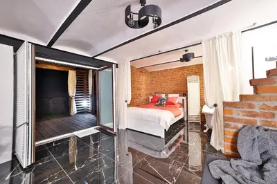 a bedroom with a bed and a brick wall at Apartament Zielona Willa in Skomielna Biała