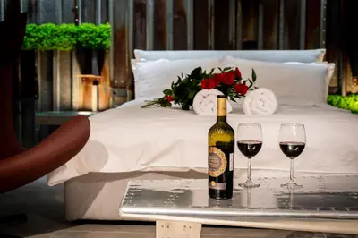 a bottle of wine and two glasses on a tray at Wiślane Tarasy - UNIQUE Apartments 4YOU - 10 piętro z pięknym widokiem na centrum Krakowa in Kraków
