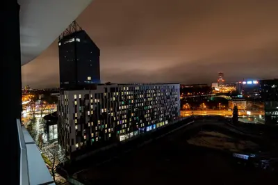 a city skyline at night with a tall building at Wiślane Tarasy - UNIQUE Apartments 4YOU - 10 piętro z pięknym widokiem na centrum Krakowa in Kraków