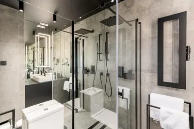 a bathroom with a shower and a toilet and a sink at Wiślane Tarasy - UNIQUE Apartments 4YOU - 10 piętro z pięknym widokiem na centrum Krakowa in Kraków