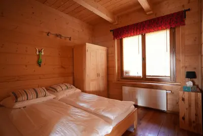a bedroom with a bed in a log cabin at Chata Palarówka in Grzechynia