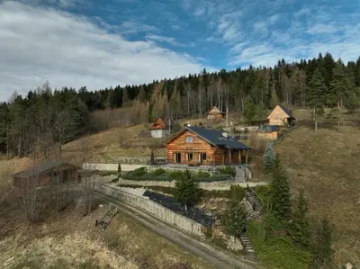 an aerial view of a log house on a hill at Chata Palarówka in Grzechynia