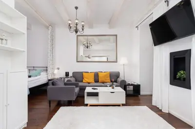 a living room with a couch and a table at Lux Studio City Center Sołtyka by Noclegi Renters in Kraków