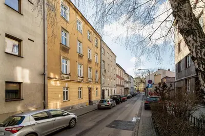 a city street with parked cars and buildings at Lux Studio City Center Sołtyka by Noclegi Renters in Kraków
