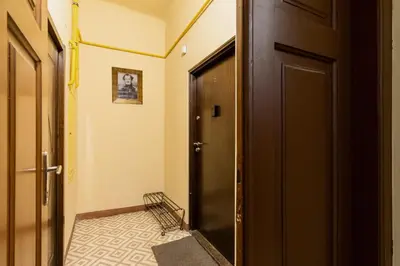 a hallway with a black door and a tile floor at Lux Studio City Center Sołtyka by Noclegi Renters in Kraków