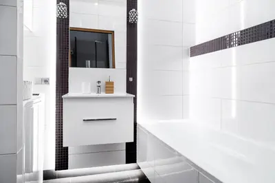 a white bathroom with a sink and a tub at Househost Apartment: Józefa 2/10 in Kraków