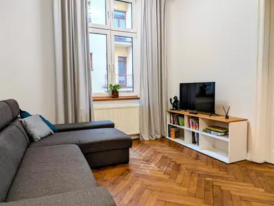 a living room with a couch and a television at Paulińska 18 by Homeprime in Kraków