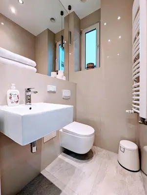 a bathroom with a white sink and a toilet at Paulińska 18 by Homeprime in Kraków