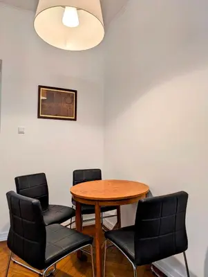 a dining room with a table and four chairs at Paulińska 18 by Homeprime in Kraków