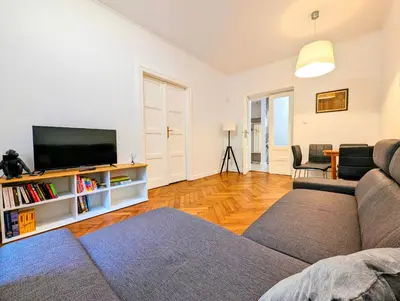a living room with a couch and a flat screen tv at Paulińska 18 by Homeprime in Kraków