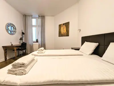 a bedroom with two beds and a desk in it at Paulińska 18 by Homeprime in Kraków