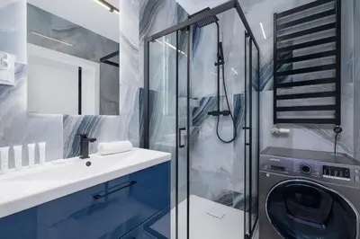 a bathroom with a sink and a washing machine at Unique Apartment with Balcony & Parking Zabłocie Cracow by Renters Prestige in Kraków