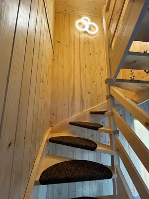 a staircase in a house with wooden walls at Domek nad Poniczanką in Rabka-Zdroj