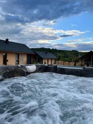 a pool of water in a yard with a house at DOMKI NA LUZIE w górach PREMIUM , dla dorosłych i młodzieży in Spytkowice