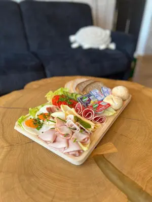 a plate of food on a wooden table at DOMKI NA LUZIE w górach PREMIUM , dla dorosłych i młodzieży in Spytkowice