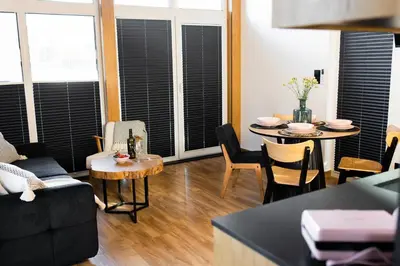 a living room with a table and chairs at DOMKI NA LUZIE w górach PREMIUM , dla dorosłych i młodzieży in Spytkowice
