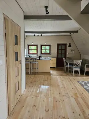 an empty room with a kitchen and a dining room at PrzyTuLasek - domek pod lasem w sercu natury, blisko Energylandii in Zator