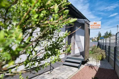 a small building with stairs next to a fence at Studio D&D Przeciszów in Przeciszów
