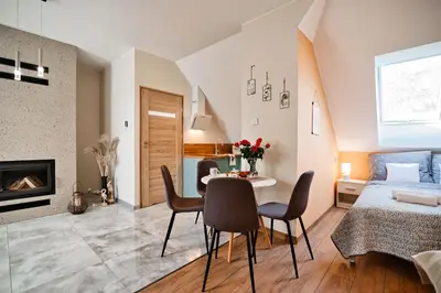 a bedroom and living room with a bed and a table and chairs at Studio D&D Przeciszów in Przeciszów
