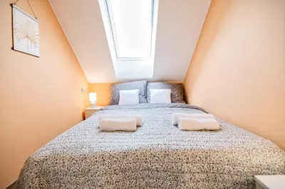 a bedroom with a bed with two pillows on it at Studio D&D Przeciszów in Przeciszów