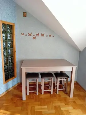 a table and two stools in a room at Orkana44F in Mszana Dolna