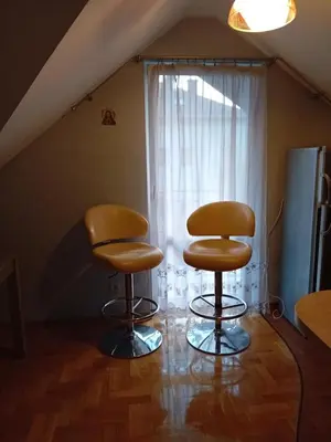 two chairs sitting in a room with a window at Orkana44F in Mszana Dolna